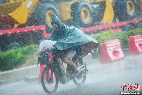 圖為南寧市民冒雨出行。中新社發(fā) 馮抒敏 攝