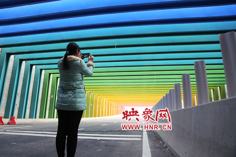 一女孩拿出手機(jī)拍照。