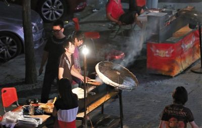 7月4日，青年路國(guó)美第一城小區(qū)附近的夜市臨街露天燒烤攤。