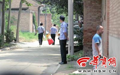 昨日，西安市閻良區(qū)譚家村，警方在事發(fā)的孫某家里勘查現(xiàn)場(chǎng)后，將提取的物證帶走 記者 黃利健 攝