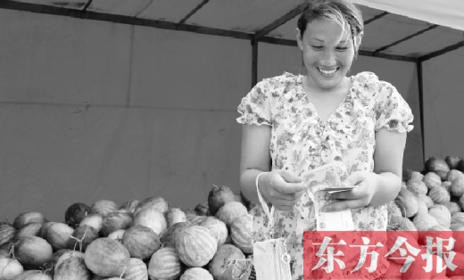 昨日，開封瓜農史瑩瑩幸福地數(shù)著賣瓜錢