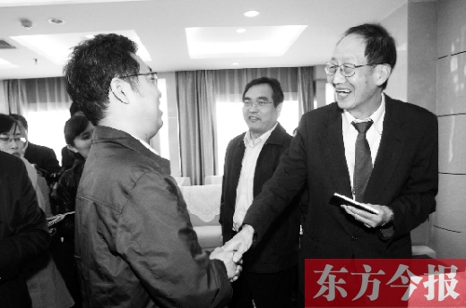 崔琦先生握手東方今報記者靳暉，感謝他把照片珍藏了15年