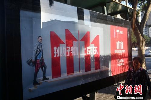 資料圖：11月1日，福州民眾從雙十一廣告牌前經(jīng)過。中新社記者 呂明 攝